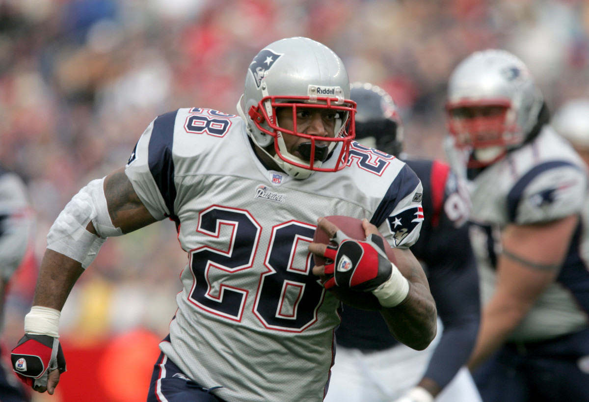Corey Dillon carries the ball for the Patriots.