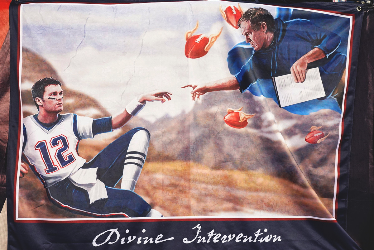A banner depicting Tom Brady and Bill Belichick in Michelangelo’s painting, ‘Creation of Adam from the Sistine Chapel.’