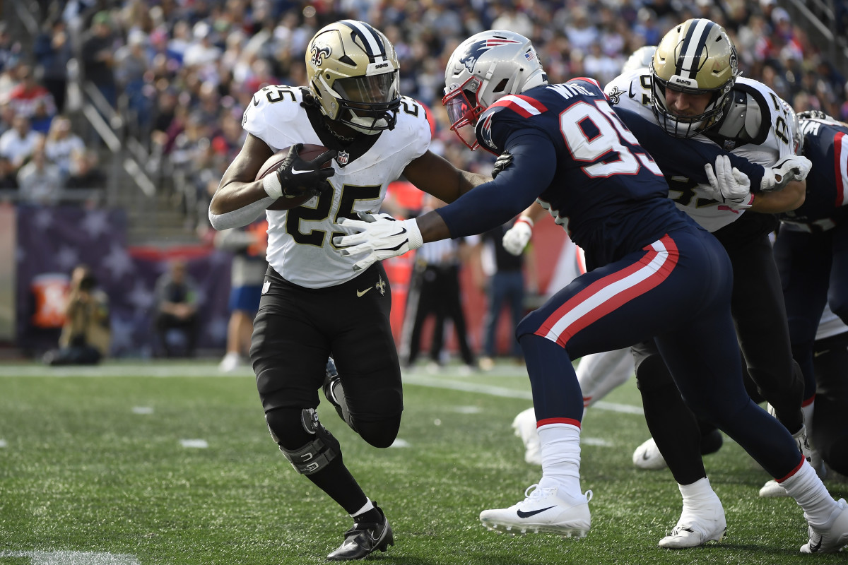 Oct 8, 2023; Foxborough, Massachusetts, USA; New England Patriots defensive end Keion White (99) tackles New Orleans Saints running back Kendre Miller (25) during the first half at Gillette Stadium. Mandatory Credit: Bob DeChiara-USA TODAY Sports  