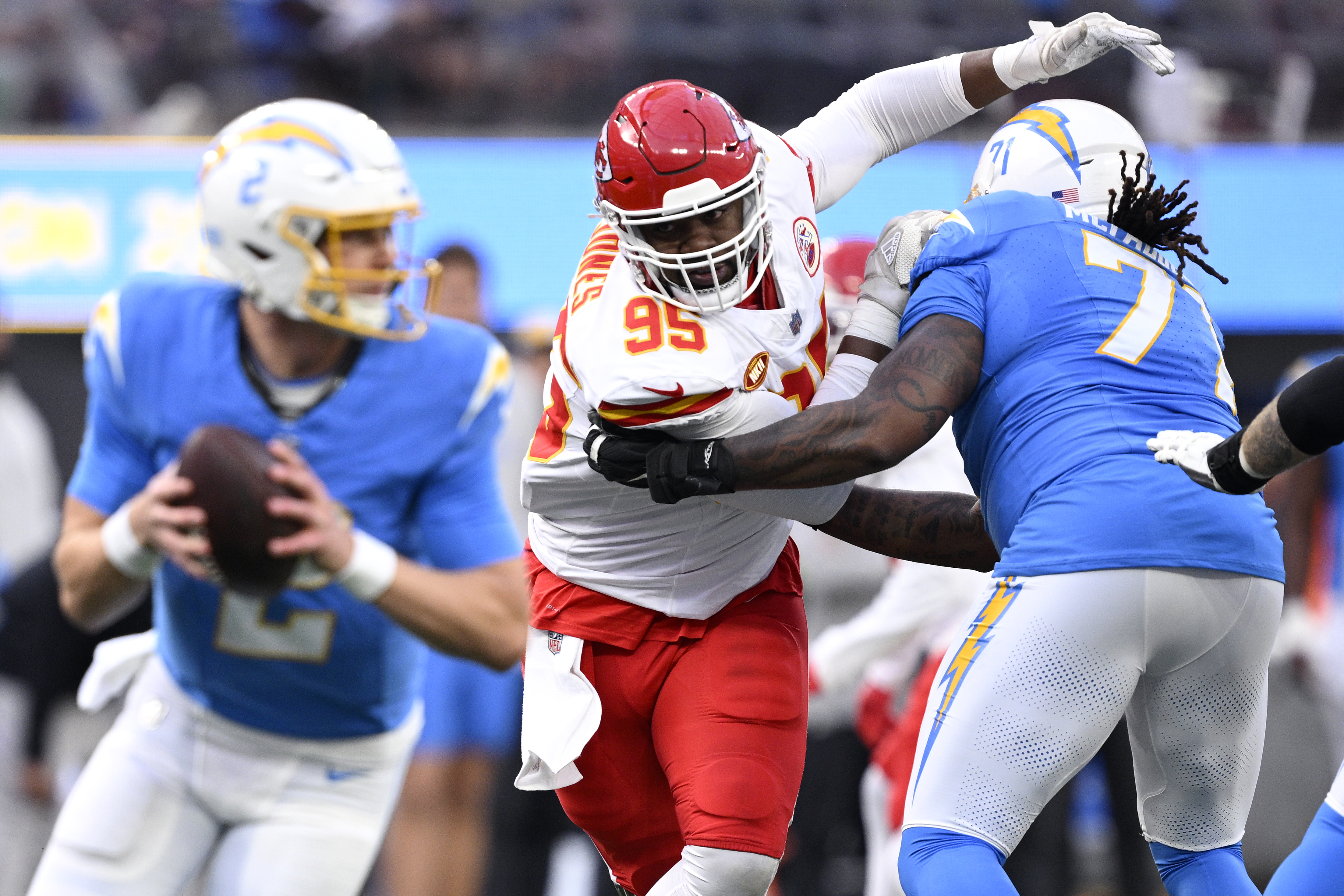 Chris Jones pushes past a Chargers player to try to sack the QB