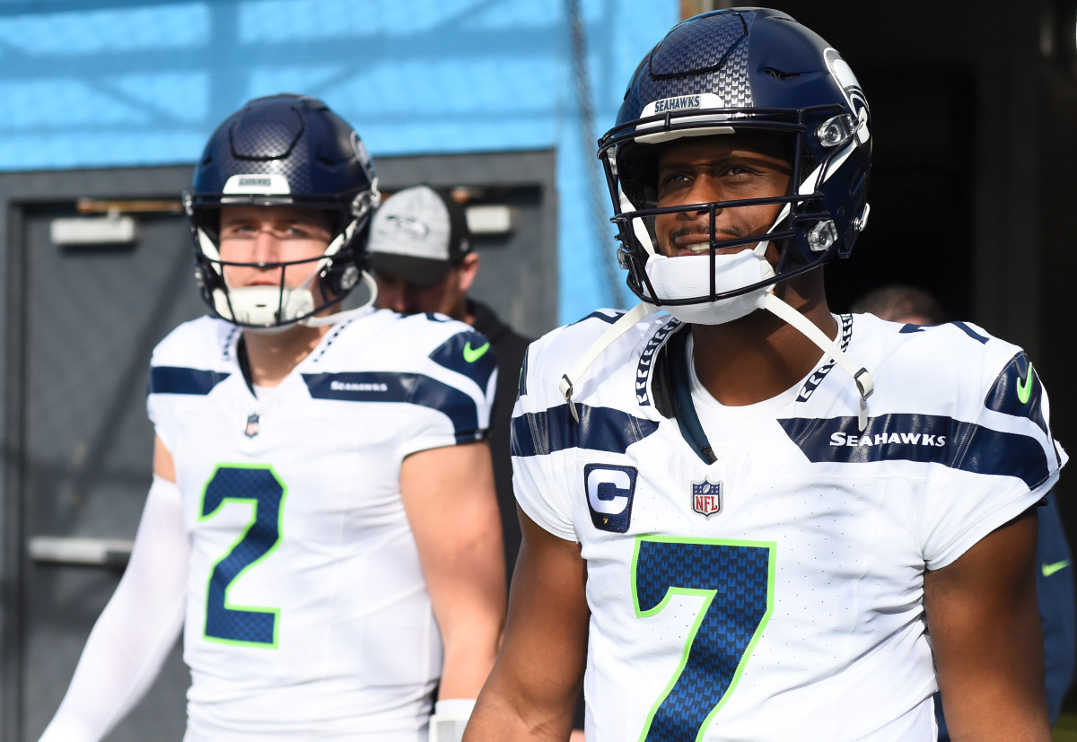 Seattle Seahawks quarterback Geno Smith (7) and quarterback Drew Lock (2) take the field before the game against the Tennessee Titans at Nissan Stadium.
