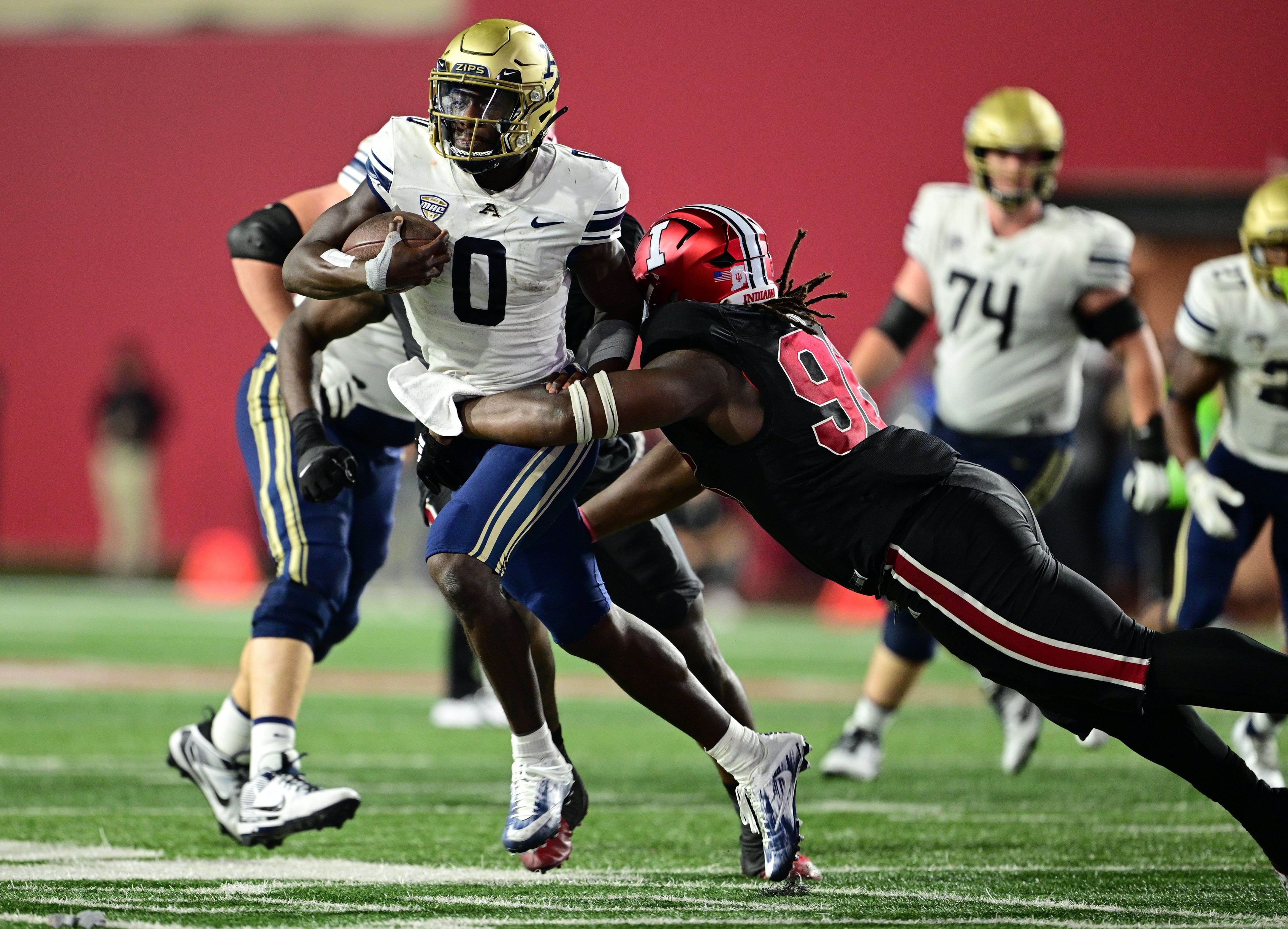 Akron Zips quarterback DJ Irons (0) is tackled by Indiana Hoosiers defensive lineman Philip Blidi (96) during the second half at Memorial Stadium. 