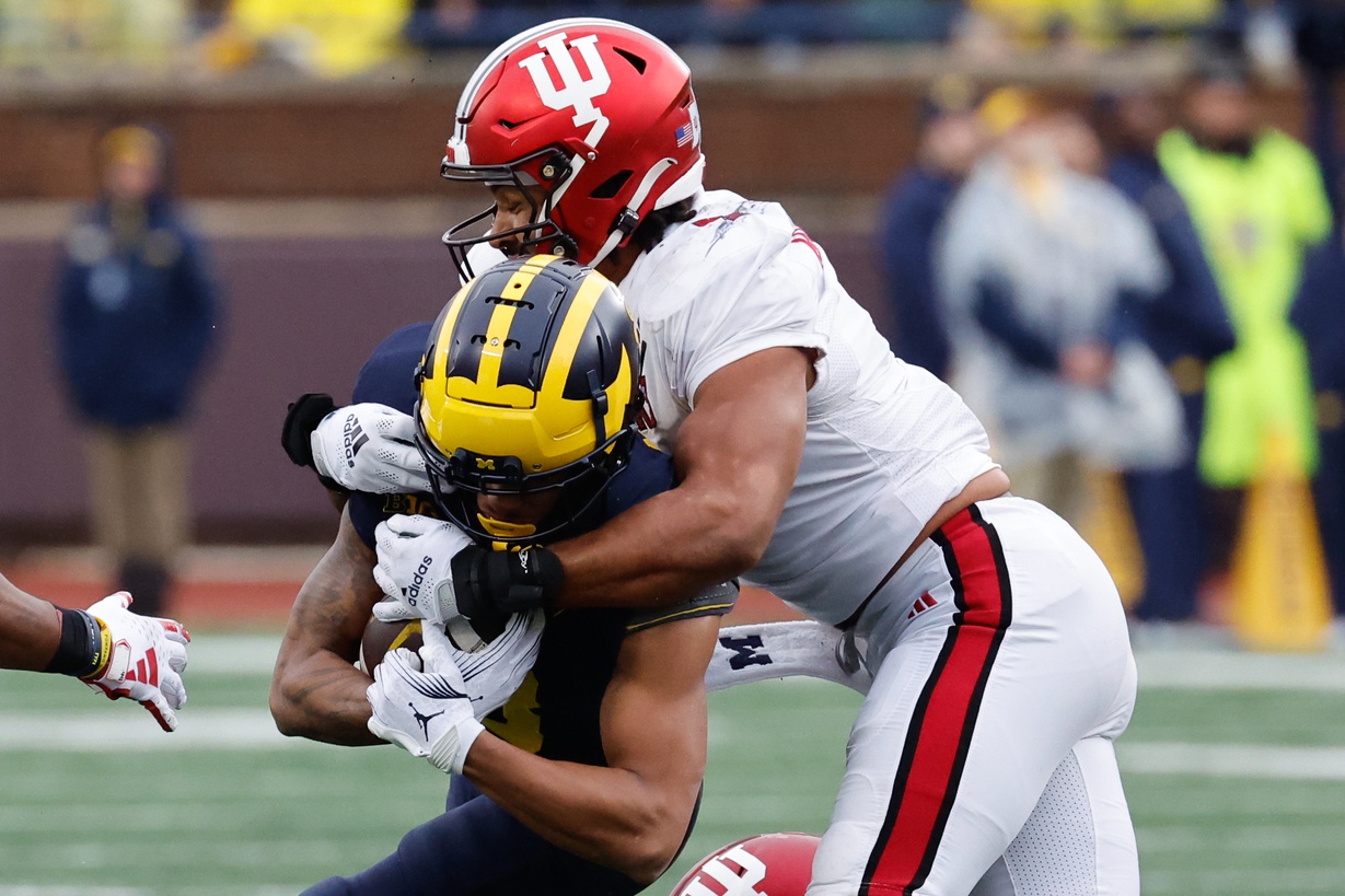 Michigan Wolverines wide receiver Tyler Morris (8) is tackled by Indiana Hoosiers linebacker Jacob Mangum-Farrar (7) in the first half at Michigan Stadium.