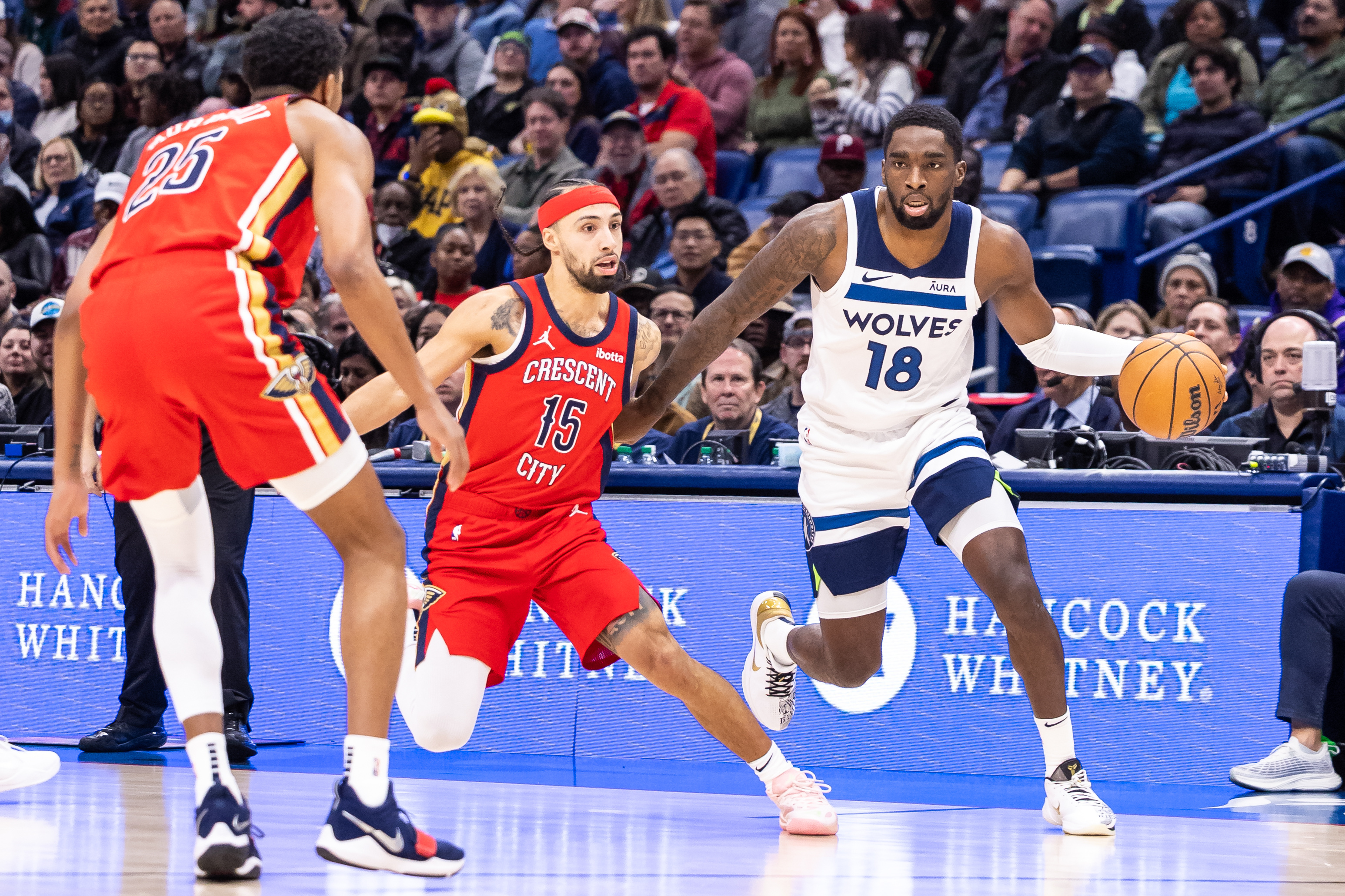 Dec 11, 2023; New Orleans, Louisiana, USA; Minnesota Timberwolves guard Shake Milton (18) dribbles against New Orleans Pelicans guard Jose Alvarado (15) during the first half at the Smoothie King Center.