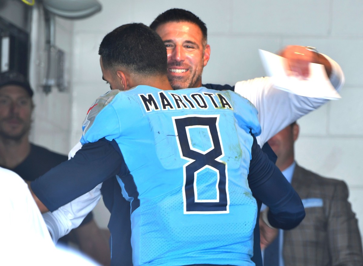 Titans quarterback Marcus Mariota (8) and Titans head coach Mike Vrabel celebrate the team's 9-6 win over the Jaguars at TIAA Bank Field Sunday, Sept. 23, 2018.
