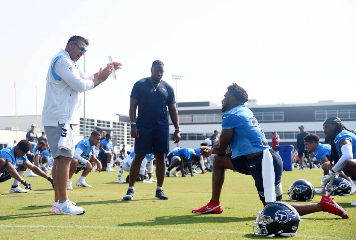 Tennessee Titans head coach Mike Vrabel talks with Tennessee Titans free safety Kevin Byard (31) as he stretches before the start of training camp at Saint Thomas Sports Park in 2021.