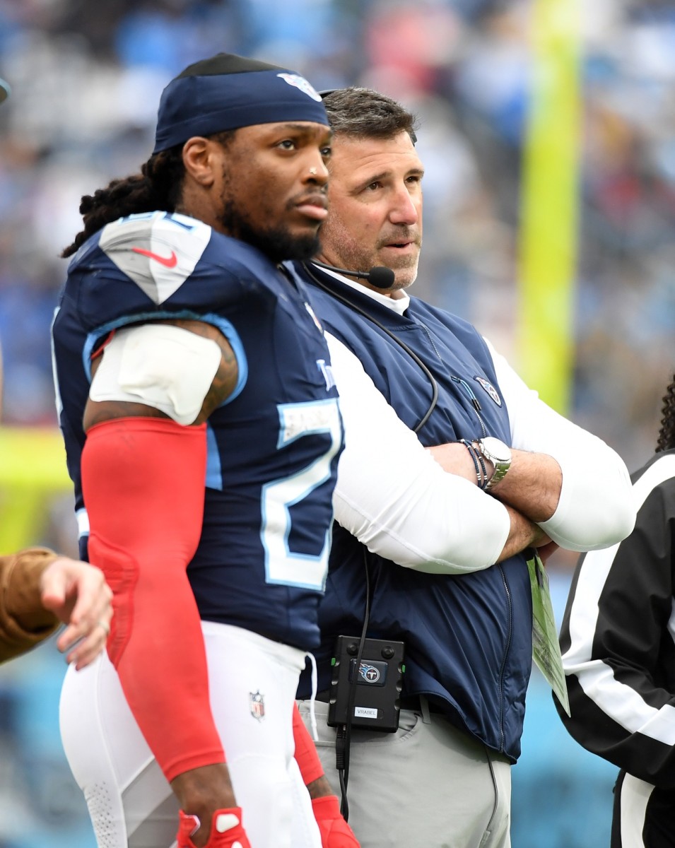 Nov 26, 2023; Nashville, Tennessee, USA; Tennessee Titans head coach Mike Vrabel running back Derrick Henry (22) watch as officials review a play during the first half against the Carolina Panthers at Nissan Stadium. 