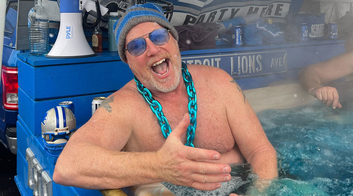 Lions fan Denny Arney sits shirtless in his tubgater