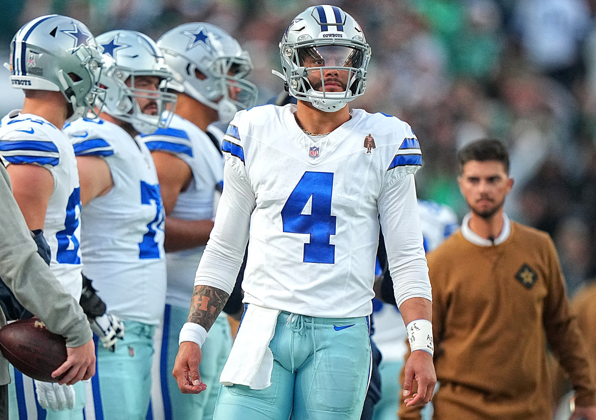Dak Prescott walks along the sideline