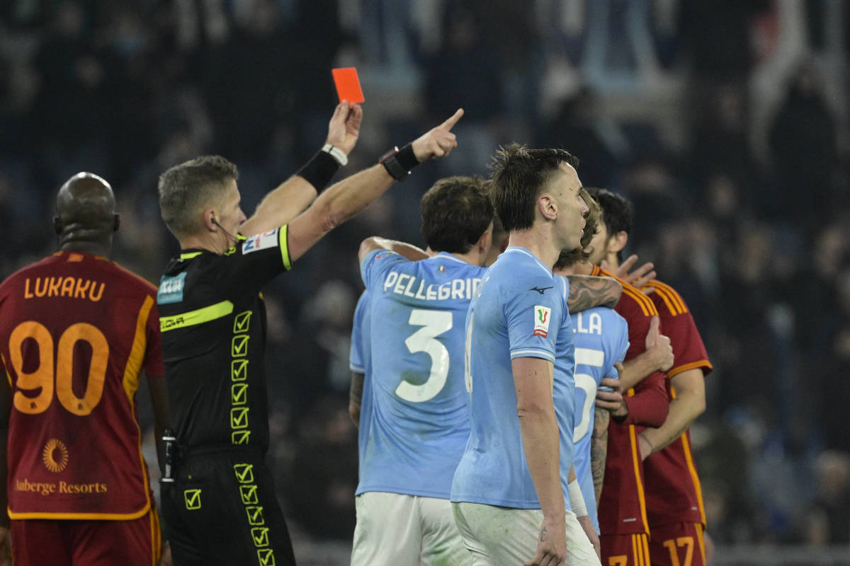 Referee Daniele Orsato pictured brandishing his red card during a Coppa Italia match between Lazio and Roma in January 2024