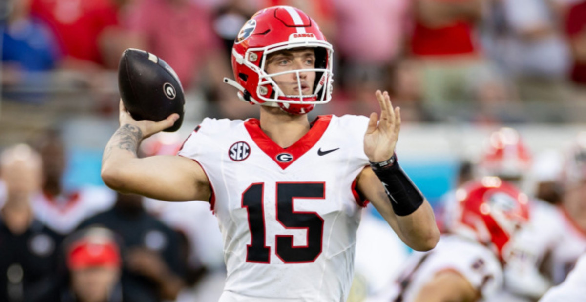 Georgia Bulldogs quarterback Carson Beck attempts a pass during a college football game in the SEC.