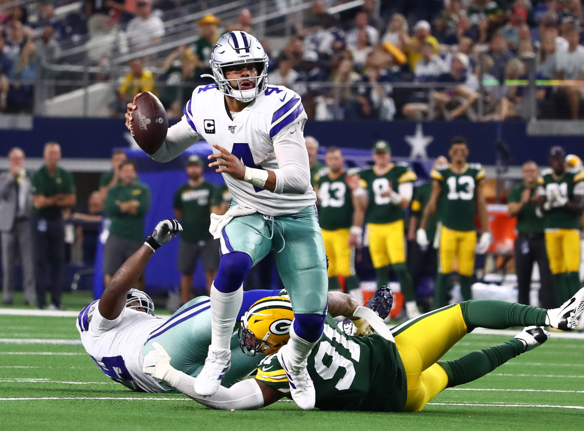 Oct 6, 2019; Arlington, TX, USA; Dallas Cowboys quarterback Dak Prescott (4) scrambles in the fourth quarter against Green Bay Packers linebacker Preston Smith (91) at AT&T Stadium. 