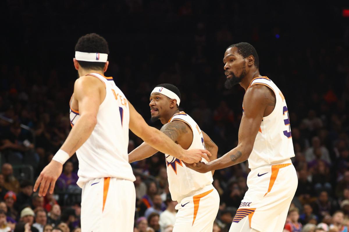 Phoenix Suns guard Devin Booker with guard Bradley Beal (3) and forward Kevin Durant (35) against the Brooklyn Nets at Footprint Center.
