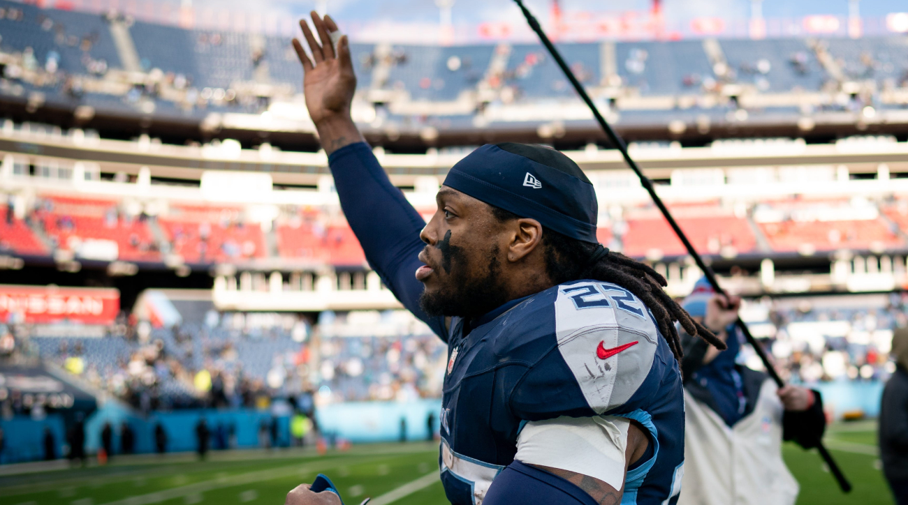 Titans running back Derrick Henry waves to the crowd as he runs off the field.