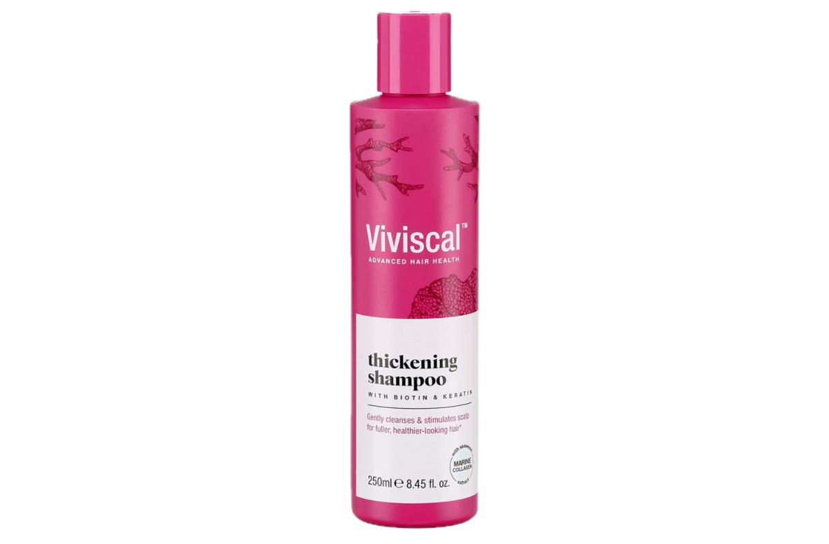 A pink bottle of Viviscal Thickening shampoo against a white background.