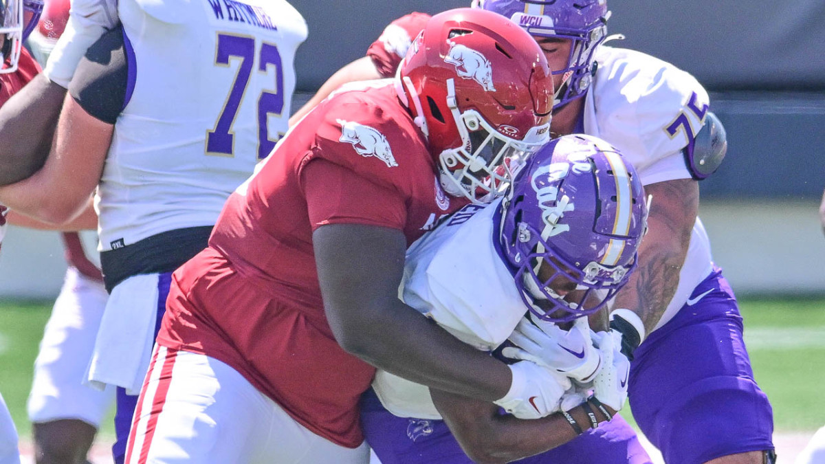 Tank Booker making a tackle for Arkansas against Western Kentucky