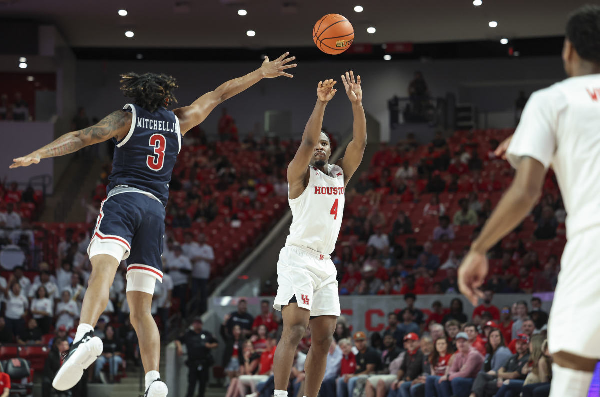 Dec 9, 2023; Houston, Texas, USA; Houston Cougars guard LJ Cryer (4) shoots the ball as Jackson State Tigers guard Jayme Mitchell (3) defends during the second half at Fertitta Center. Mandatory Credit: Troy Taormina-USA TODAY Sports