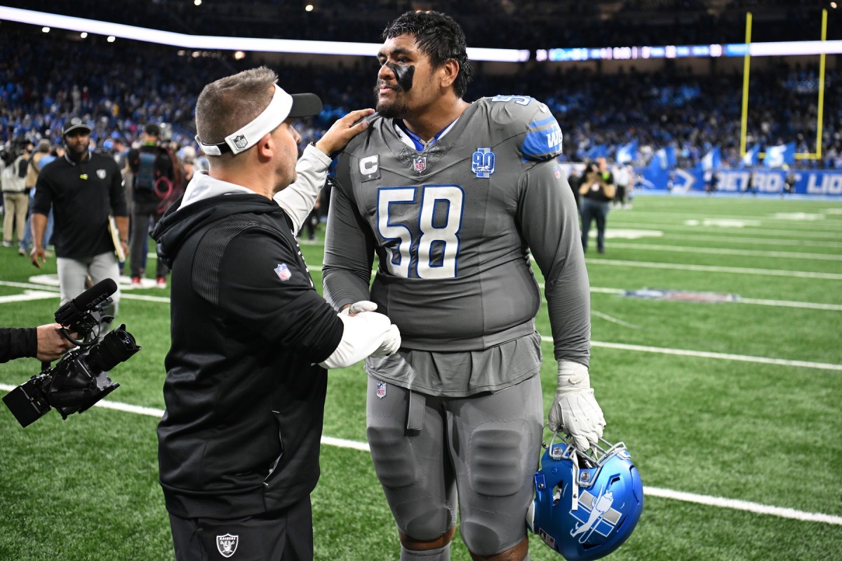 Oct 30, 2023; Detroit, Michigan, USA; Las Vegas Raiders head coach Josh McDaniels congratulates Detroit Lions offensive tackle Penei Sewell (58) after the Lions beat the Raiders in Monday Night Football at Ford Field. 