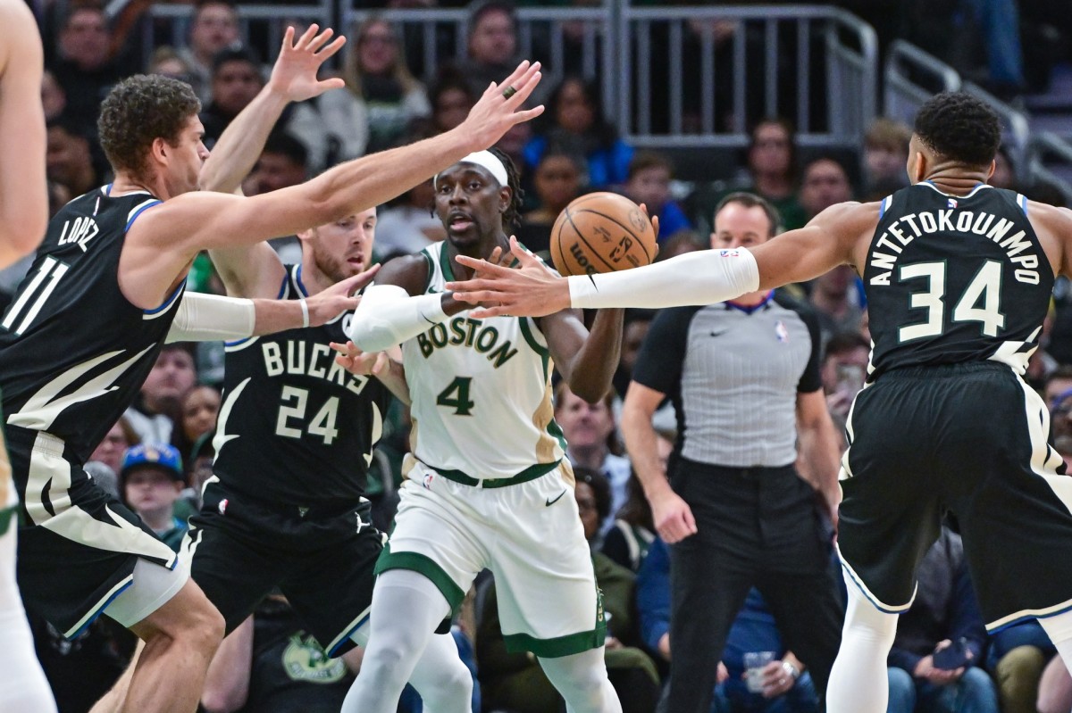 Boston Celtics guard Jrue Holiday (4) gets pressure from Milwaukee Bucks center Brook Lopez (11), guard Pat Connaughton (24) and forward Giannis Antetokounmpo (34) 