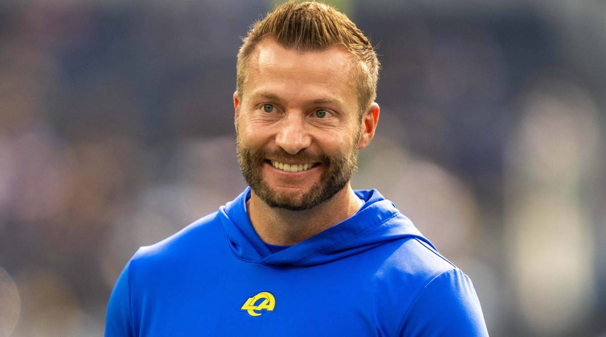 Los Angeles Rams head coach Sean McVay smiles while on the field before a game.