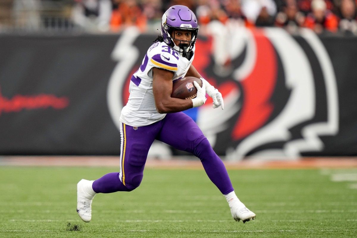 Minnesota Vikings running back Ty Chandler (32) carries the ball in the third quarter of a Week 15 NFL football game between the Minnesota Vikings and the Cincinnati Bengals, Saturday, Dec. 16, 2023, at Paycor Stadium in Cincinnati.