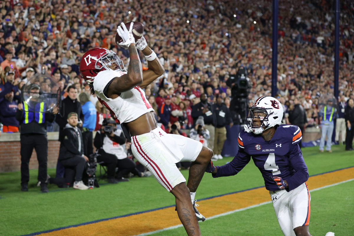 ov 25, 2023; Auburn, Alabama, USA; Alabama Crimson Tide wide receiver Isaiah Bond (17) scores the game winning touchdown over Auburn Tigers cornerback D.J. James (4) during the fourth quarter at Jordan-Hare Stadium. Mandatory Credit: John Reed-USA TODAY Sports