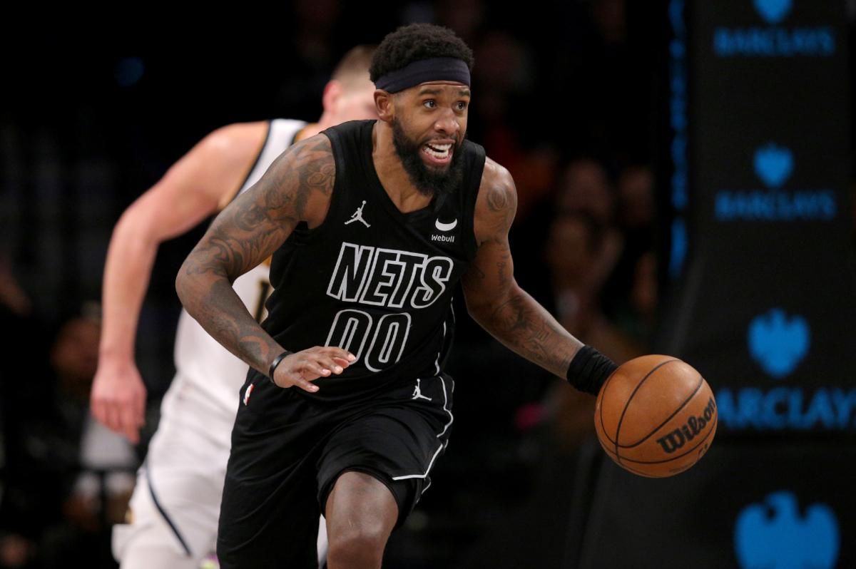 Brooklyn Nets forward Royce O'Neale (00) brings the ball up court against the Denver Nuggets during the third quarter at Barclays Center.