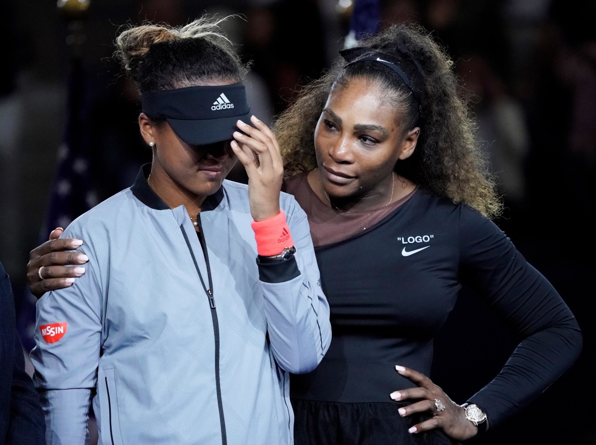 Naomi Osaka cries as the crowd boos and Serena Williams comforts her after winning the U.S. Open women’s singles title in 2018.