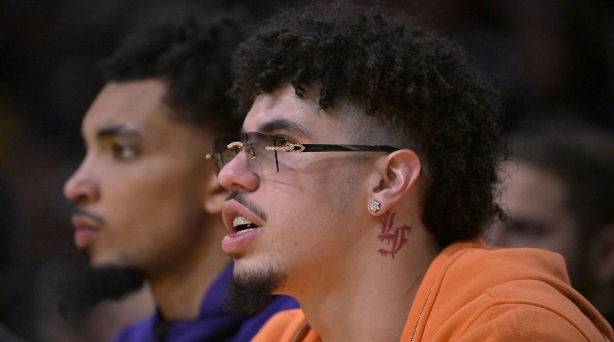 Charlotte Hornets point guard LaMelo Ball looks on from the bench while not playing in a game.