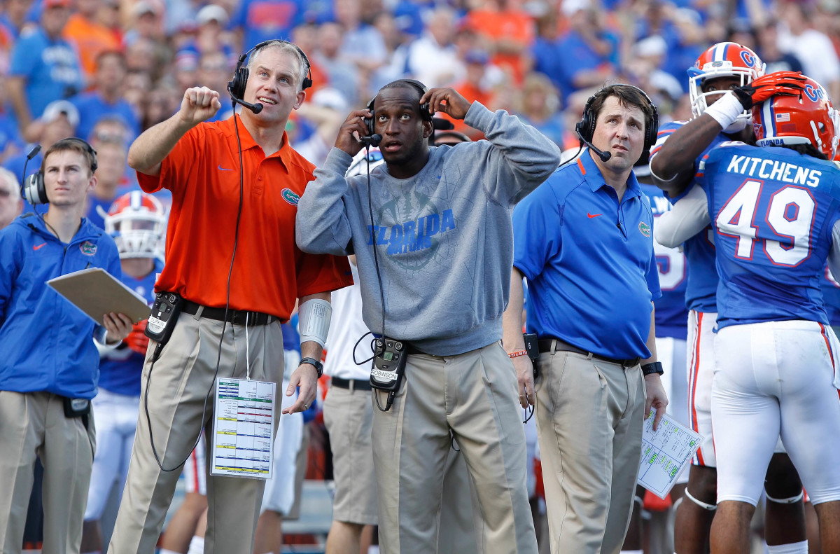 Nov 23, 2013; Gainesville, FL, USA; Florida Gators defensive coordinator D.J. Durkin, defensive backs coach Travaris Robinson and head coach Will Muschamp during the second quarter against the Georgia Southern Eagles at Ben Hill Griffin Stadium. (Kim Klement / USA TODAY Sports).