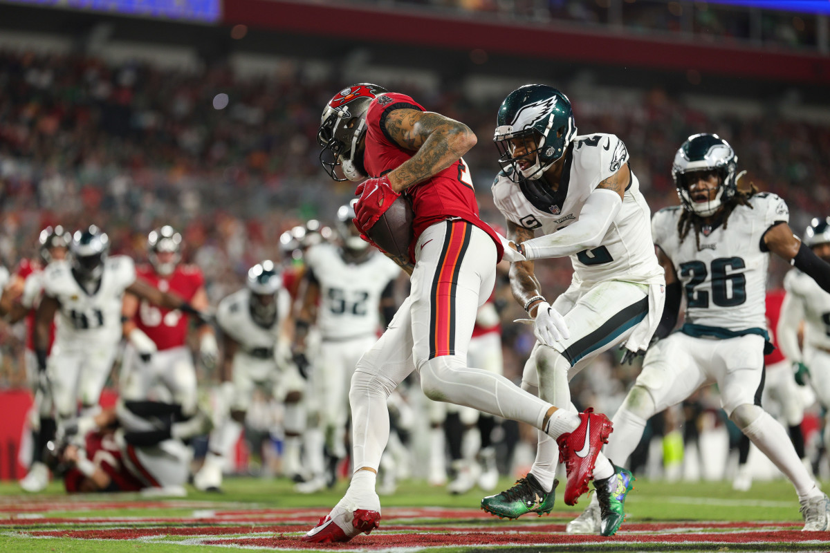 Sep 25, 2023; Tampa, Florida, USA; Tampa Bay Buccaneers wide receiver Mike Evans (13) catches a touchdown pass defended by Philadelphia Eagles cornerback Darius Slay (2) in the fourth quarter at Raymond James Stadium. Mandatory Credit: Nathan Ray Seebeck-USA TODAY Sports