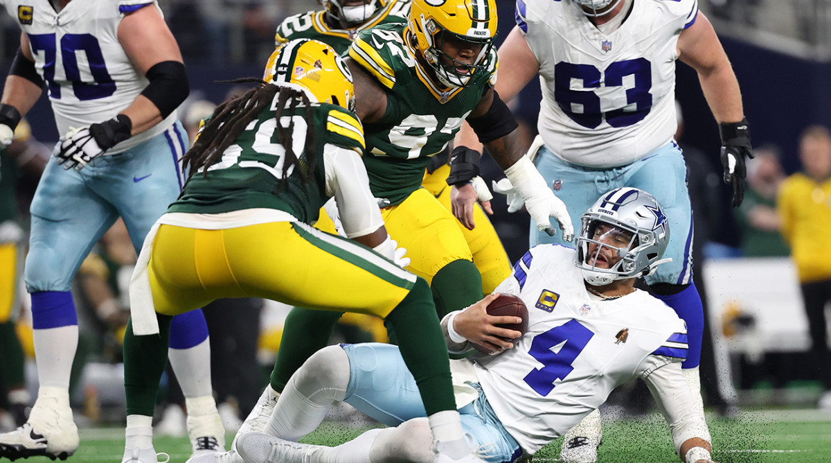 Dallas Cowboys quarterback Dak Prescott (4) slides after running the ball against the Green Bay Packers in the second half for the 2024 NFC wild-card game at AT&T Stadium.