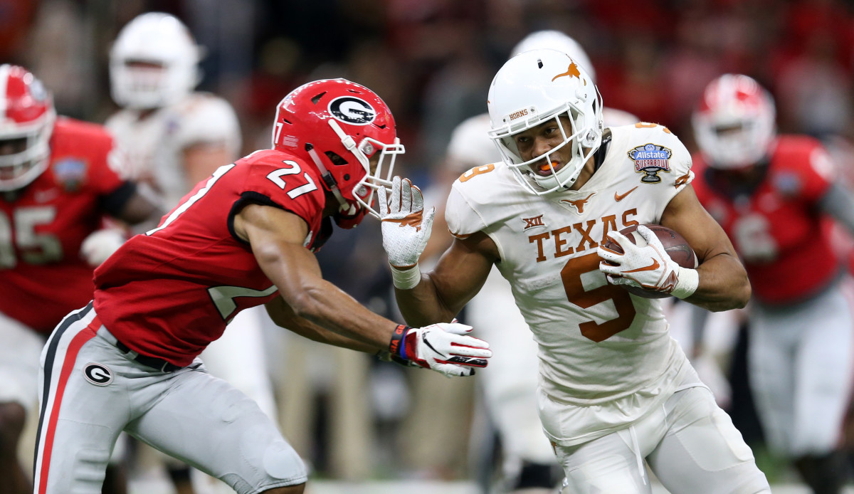 Jan 1, 2019; New Orleans, LA, USA; Texas Longhorns wide receiver Collin Johnson (9) runs against Georgia Bulldogs defensive back Eric Stokes (27) after a catch in the second half of the 2019 Sugar Bowl at the Mercedes-Benz Superdome. The Texas Longhorns won 28-21. © Chuck Cook-USA TODAY Sports
