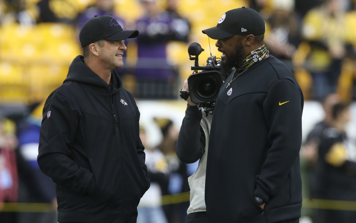 Dec 5, 2021; Pittsburgh, Pennsylvania, USA; Baltimore Ravens head coach John Harbaugh (left) and Pittsburgh Steelers head coach Mike Tomlin (right) talk on the field before their teams play at Heinz Field. 