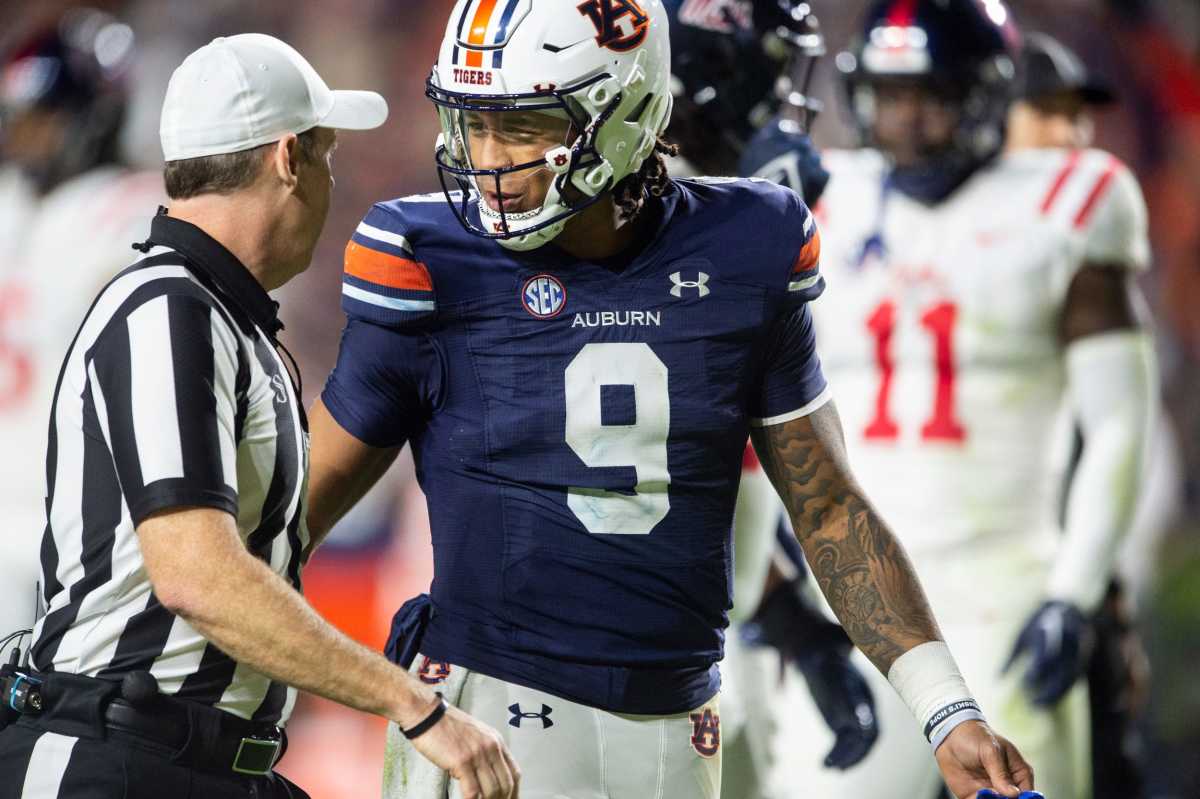Robby Ashford talks with the official after a penalty in Auburn's 2023 matchup vs. Ole Miss
