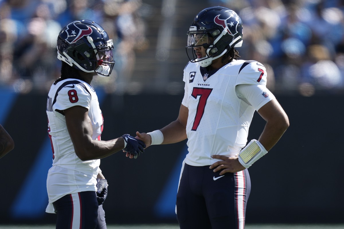 Houston Texans wide receiver John Metchie III (8) shakes hands with quarterback C.J. Stroud (7) during a time out to check for a touchdown run during the second quarter against the Carolina Panthers at Bank of America Stadium.