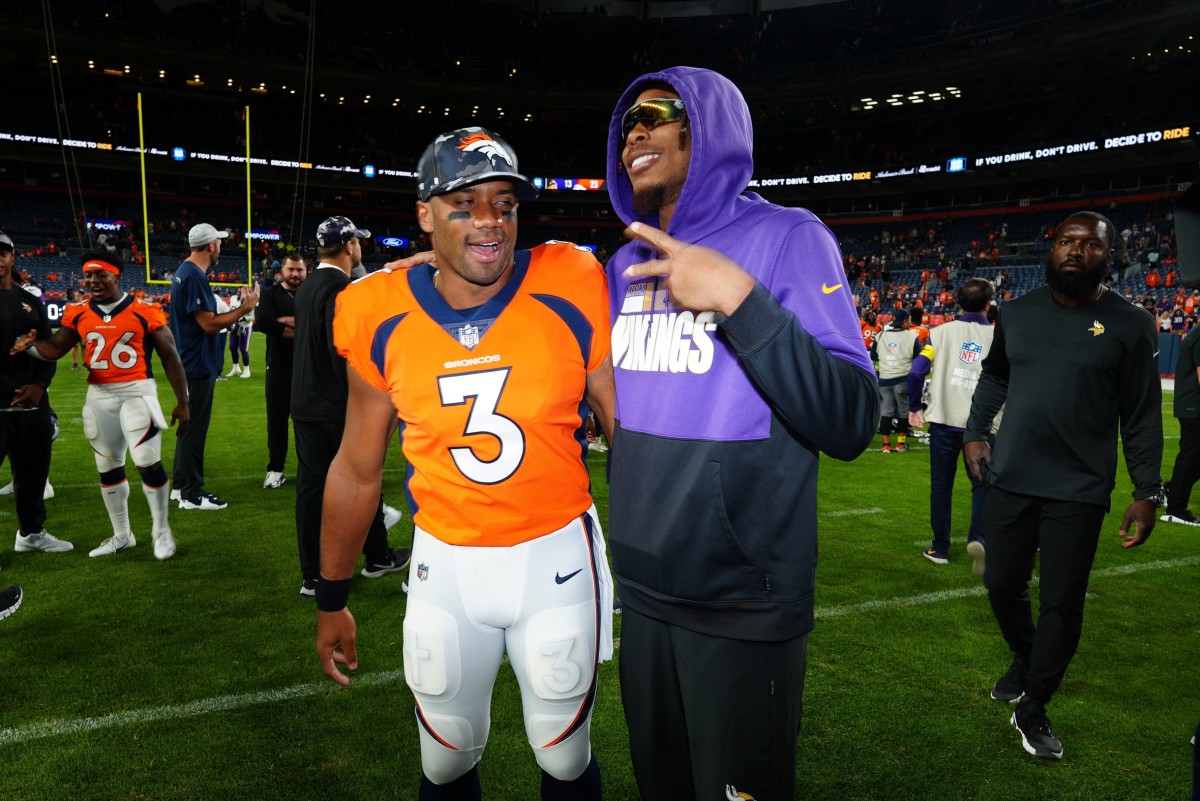 Aug 27, 2022; Denver, Colorado, USA; Denver Broncos quarterback Russell Wilson (3) and Minnesota Vikings wide receiver Justin Jefferson (18) meet following a preseason game at Empower Field at Mile High. 