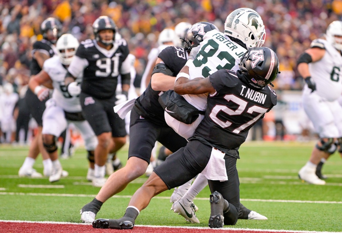 Oct 28, 2023; Minneapolis, Minnesota, USA; Minnesota Golden Gophers defensive back Tyler Nubin (27) and linebacker Ryan Selig (33) prevent Michigan State Spartans wide receiver Montorie Foster Jr. (83) from converting on a two-point try during the fourth quarter at Huntington Bank Stadium. 
