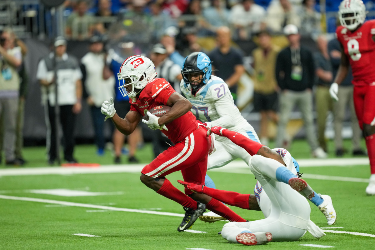 May 13, 2023; San Antonio, TX, USA; DC Defenders wide receiver Josh Hammond (0) runs away from Arlington Renegades linebacker Edmond Robinson (30) and defensive back Brandon Rusnak (27) in the second half at the Alamodome. Mandatory Credit: Daniel Dunn-USA TODAY Sports