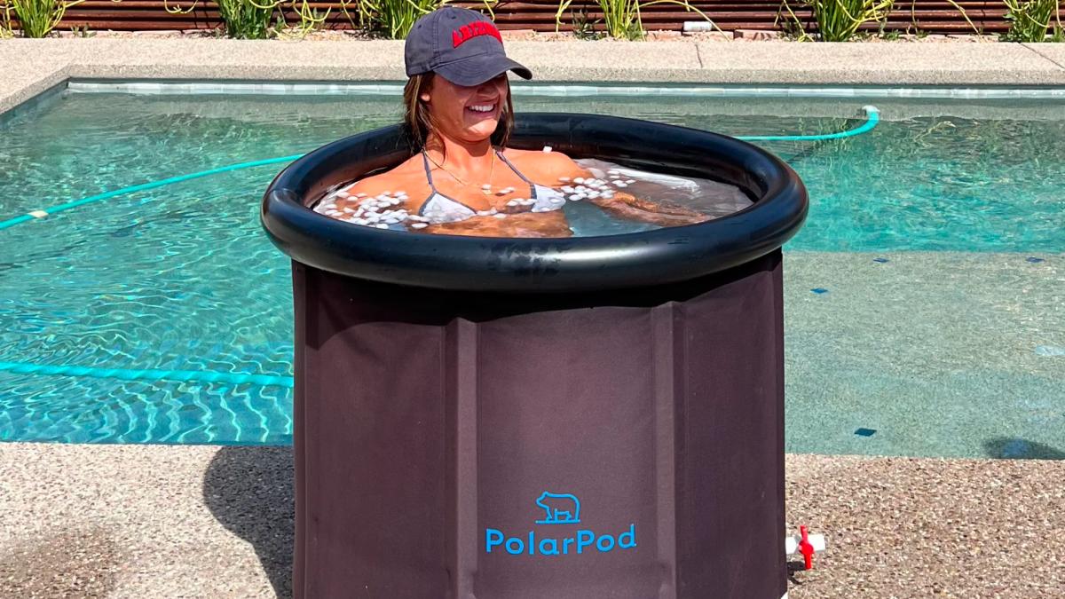 Woman soaking in PolarPod Ice Bath by pool