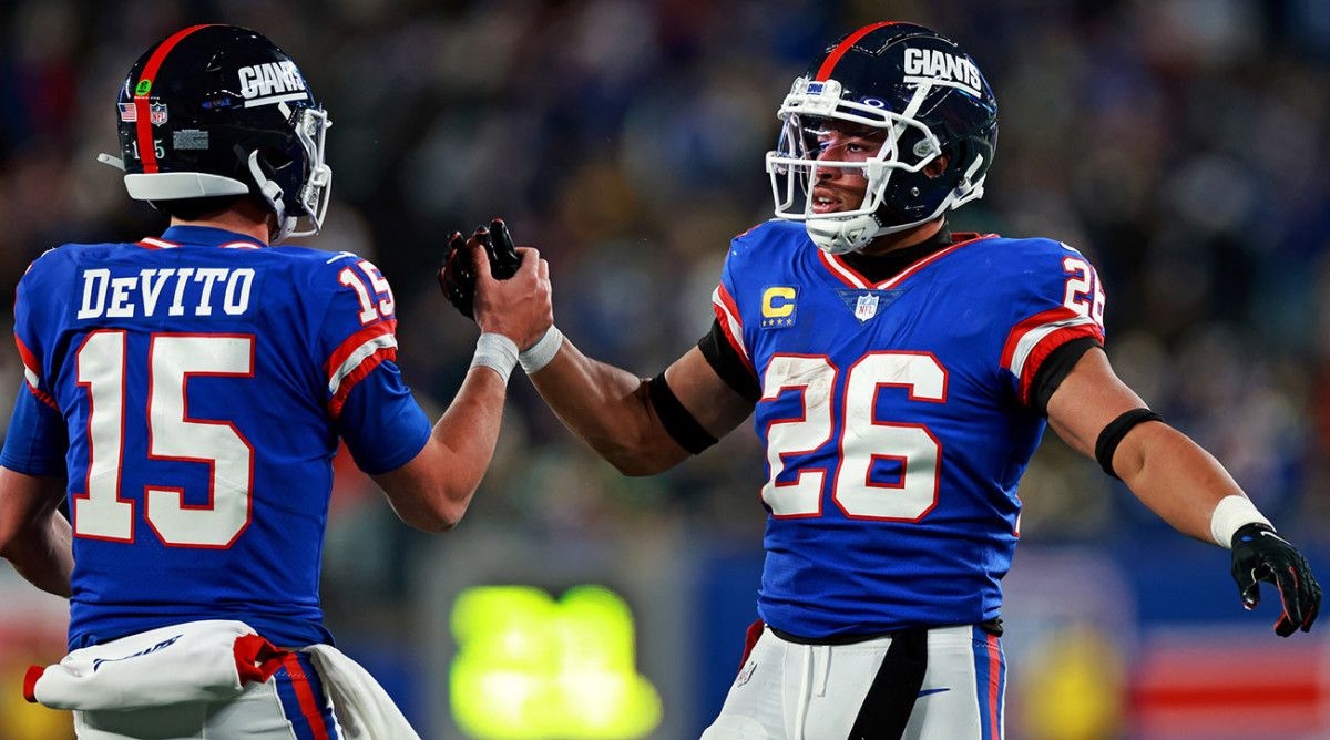 Tommy DeVito celebrates a touchdown with Saquon Barkley.