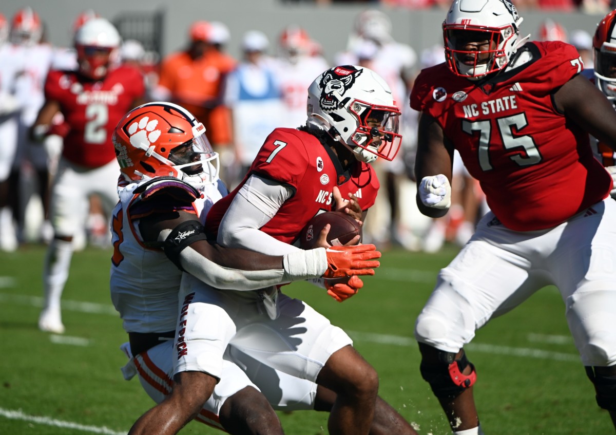 Oct 28, 2023; Raleigh, North Carolina, USANorth Carolina State Wolfpack quarterback MJ Morris (7) is sacked by Clemson Tigers defensive tackle Ruke Orhorhoro (33) during the first half at Carter-Finley Stadium. Mandatory Credit: Rob Kinnan-USA TODAY Sports  