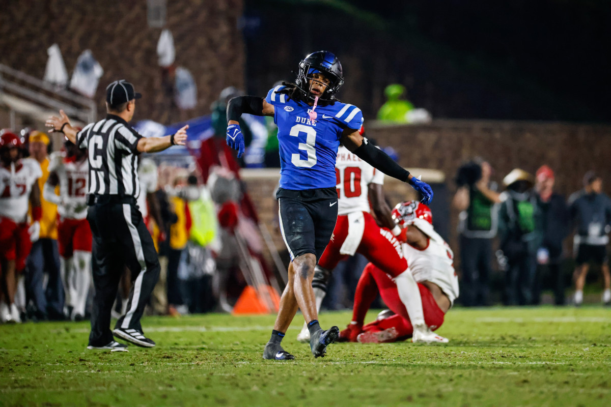 Duke Blue Devils nose tackle Brandon Johnson (3) celebrates his tackle against North Carolina State Wolfpack quarterback MJ Morris (7).