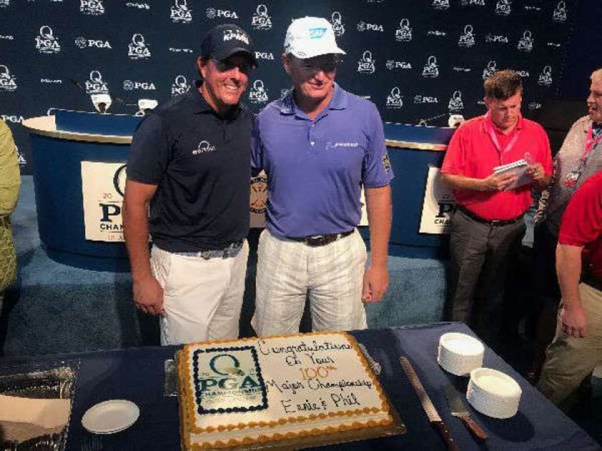 PHOTO BY ADAM SCHUPAK  Phil Mickelson (left) and Ernie Els celebrate their 100th major-championship starts.