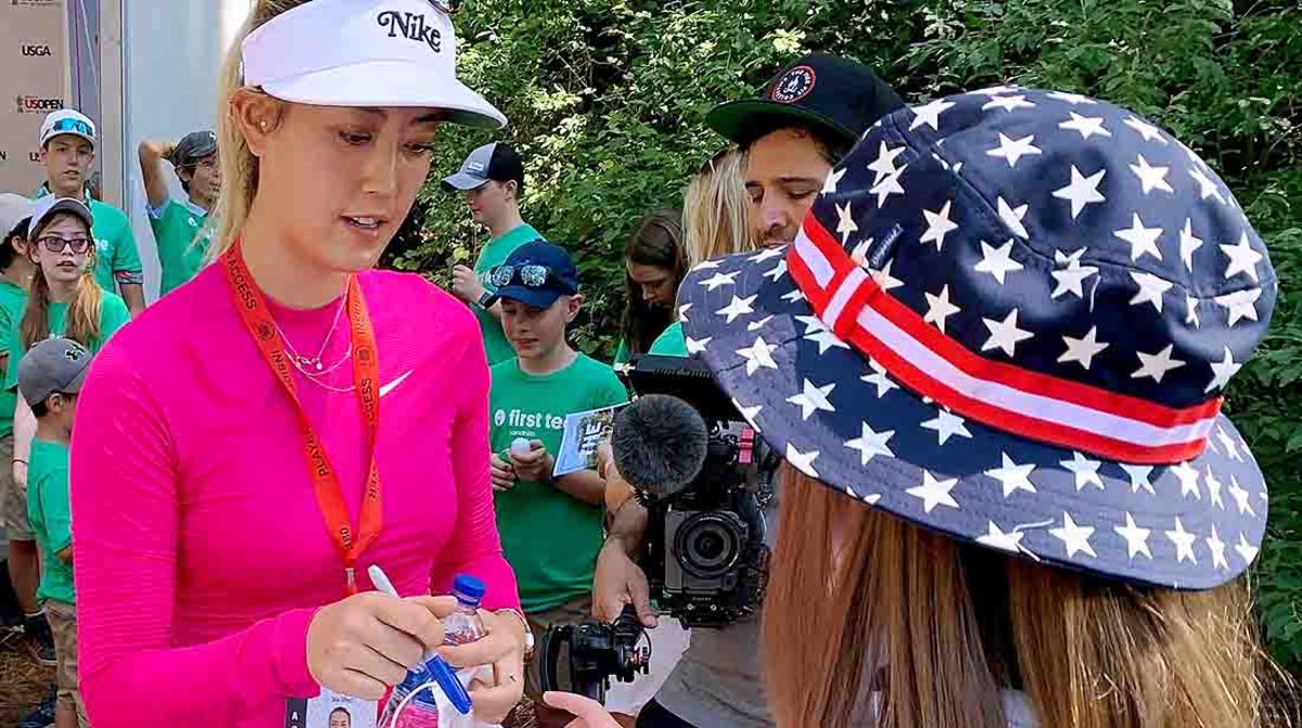 Michelle Wie signs autographs for kids at the 2022 U.S. Women's Open.