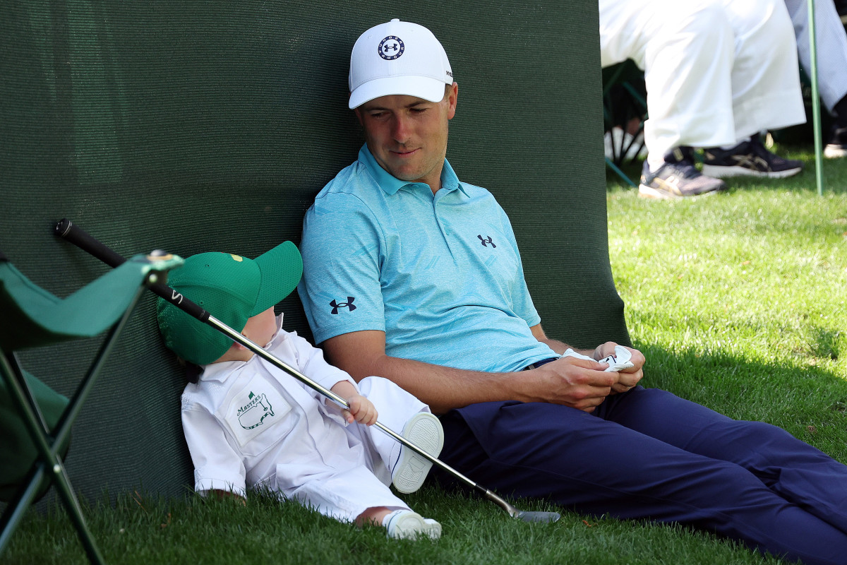 Jordan Spieth looks on with his son, Sammy Spieth, during the Par 3 contest prior to the 2023 Masters Tournament.