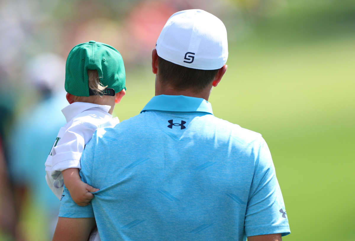 Jordan Spieth walks down the fairway at the Masters Par 3 contest with his son, Sammy.