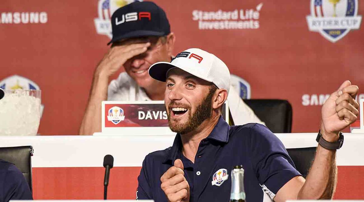 Dustin Johnson and Captain Davis Love III of Team USA speak during a press conference following the team's victory at the 2016 Ryder Cup at Hazeltine National Golf Club.