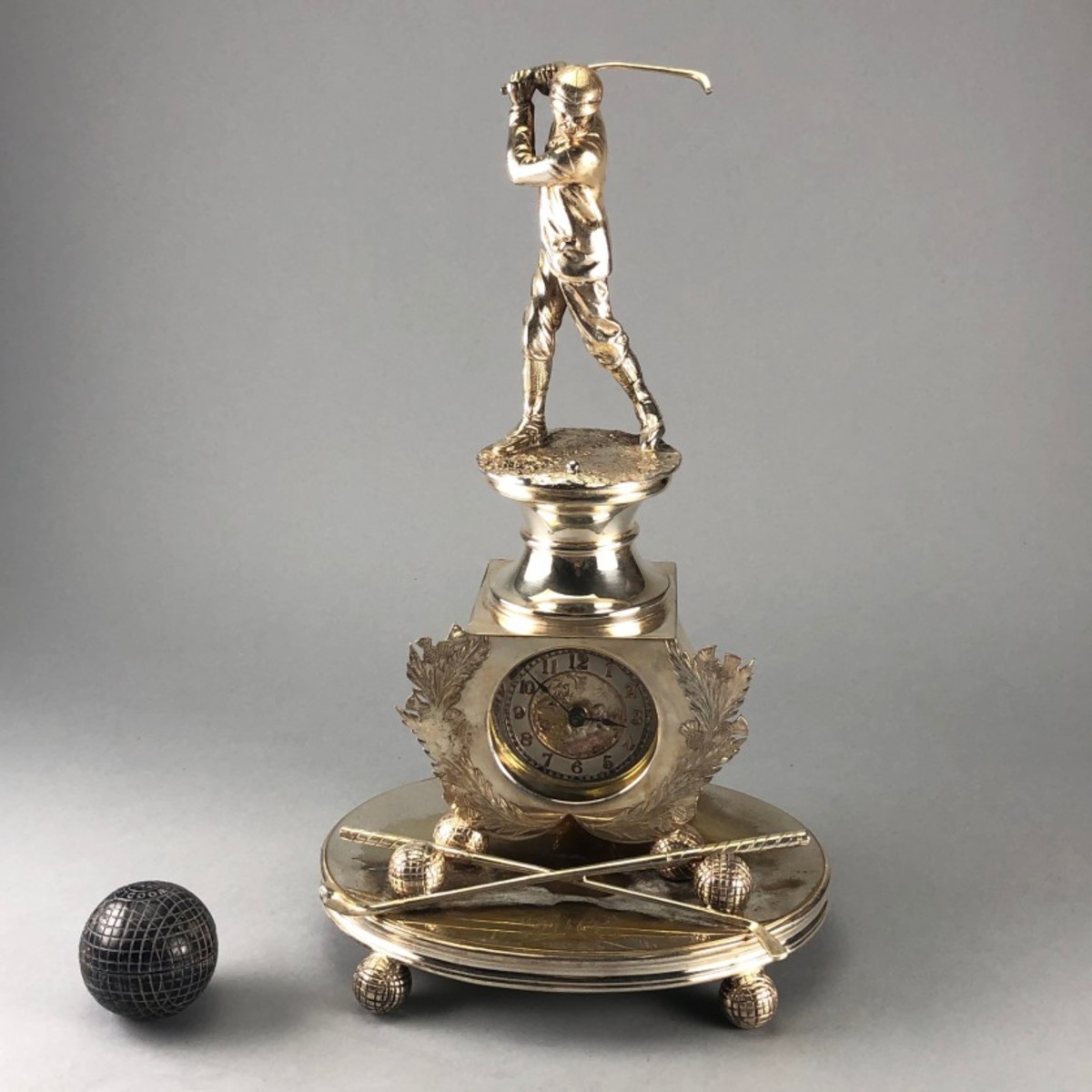 An 1880s sculptural clock with a solid gutta-percha ball from the 1890s 