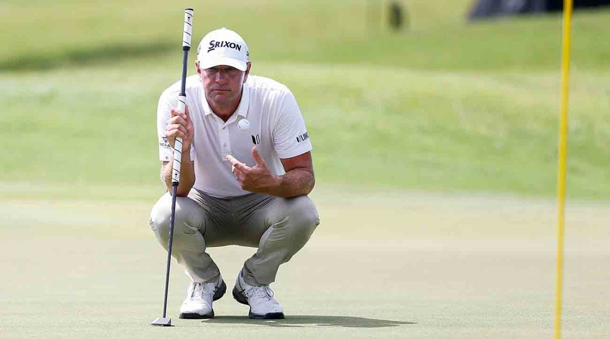 Lucas Glover catches a ball as he plans out his putt on the ninth hole during the second round of the 2023 FedEx St. Jude Championship at TPC Southwind in Memphis, Tenn.